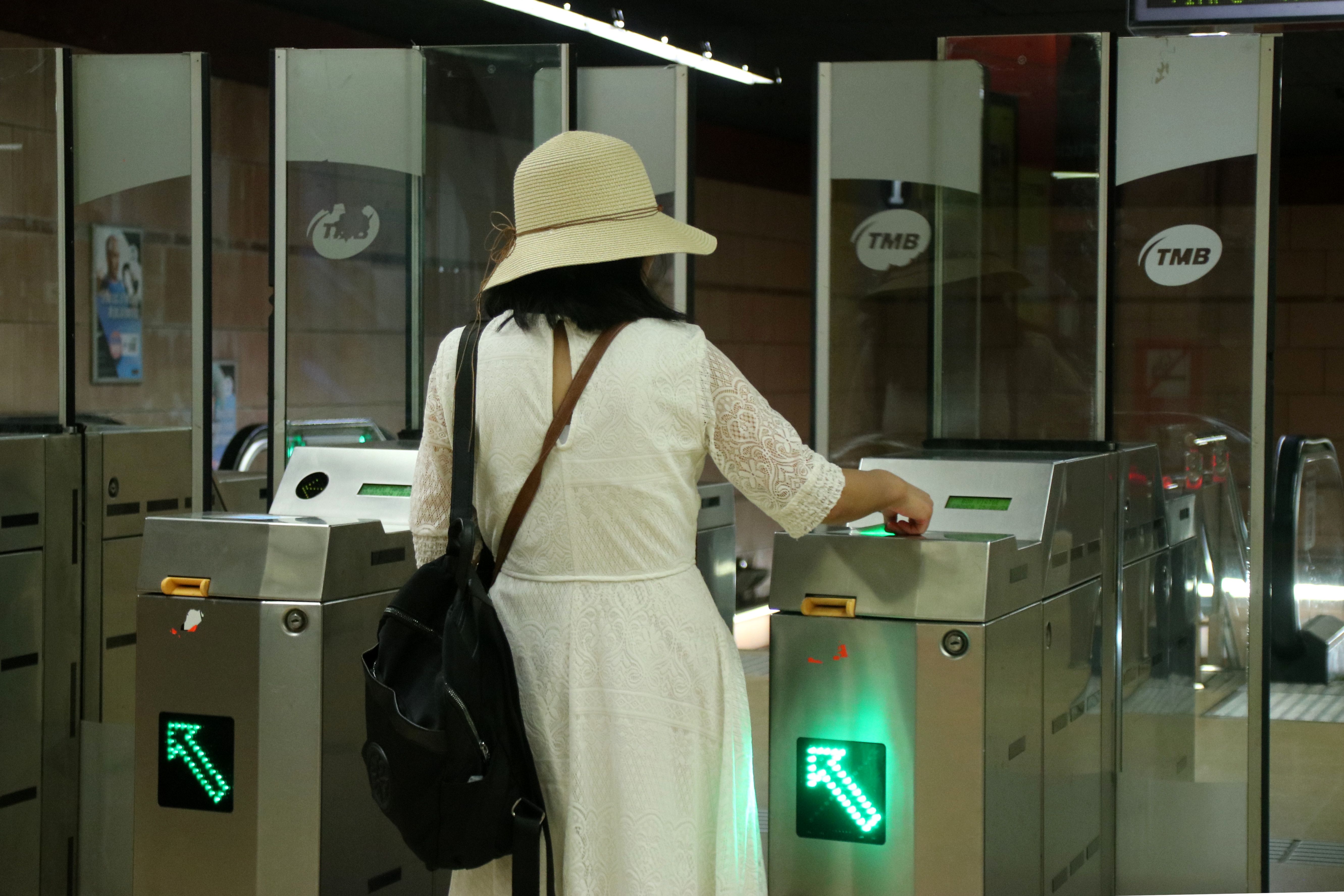 Una usuaria validando su T-Mobilitat en el metro en la estación de La Pau | ACN