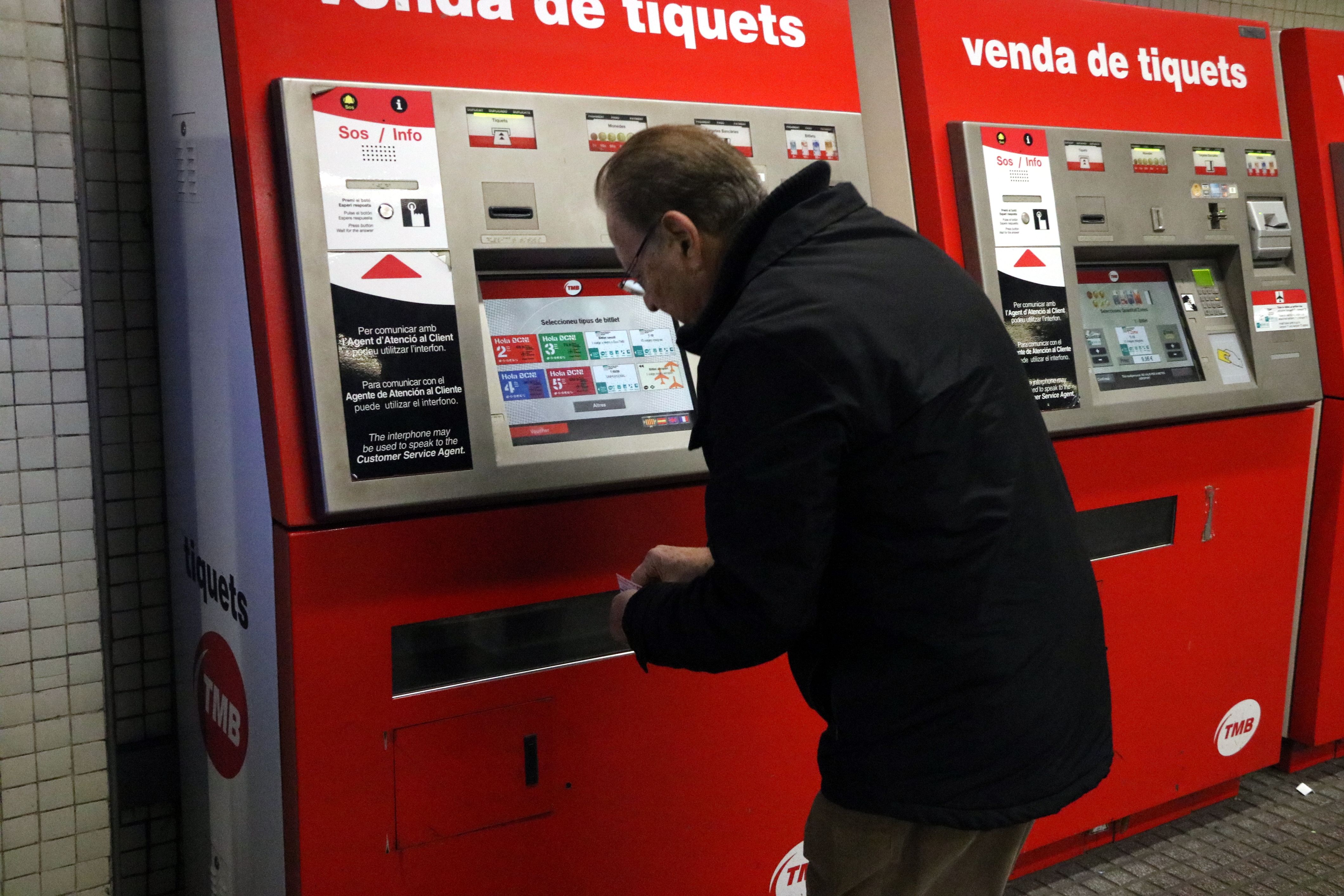 Imatge d'un usuari de metro agafant un bitllet de la màquina expenedora | ACN